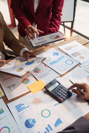 Close up of Diverse colleagues gather brainstorm discuss financial statistics at office meeting. finance, teamwork, Big data Graphs Charts conceptの写真素材