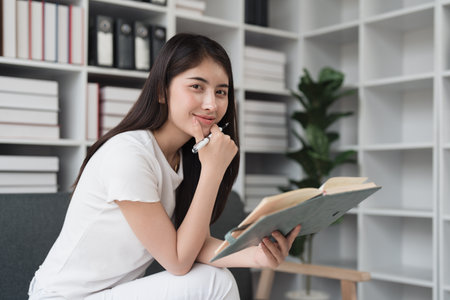 Attractive Asian woman resting comfortable living room and reading book, Relax, Sofa, Lifestyleの写真素材
