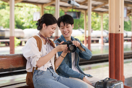 Asian couple at railway station have happy moment. Tourism and travel in the summerの写真素材