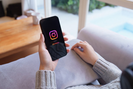CHIANG MAI, THAILAND - APR 21, 2023: Woman hand using Iphone 14 with Instagram application on the screen by metaverse, Instagram is a photo-sharing app for smartphonesのeditorial素材