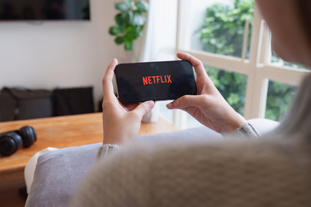 CHIANG MAI, THAILAND APR 21, 2023: Netflix logo on iPhone screen. Netflix is an international leading subscription service for watching TV episodes and moviesのeditorial素材