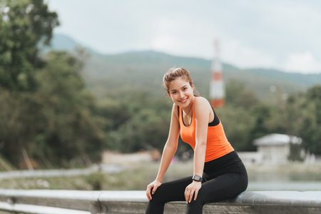 Healthy Asian woman is jogging outdoor. Fitness girl running. Female exercising at outdoor park