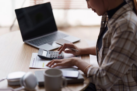 Accountant asian woman working on laptop and do document, tax, exchange, accounting and Financial advisor conceptの写真素材