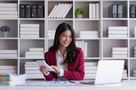 Accountant asian woman working on laptop and do document, tax, exchange, accounting and Financial advisor conceptの写真素材