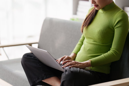 Attractive Asian woman resting comfortable living room and using laptop computer and listen to music, Relax, Sofa, Lifestyleの写真素材