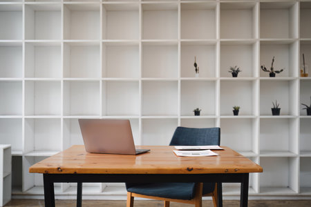 Front view laptop on wooden table at office. Financial document paper report on table. In modern office workplaceの写真素材