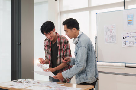 Team of ux developer and ui designer brainstorming interface wireframe design.Creative digital...