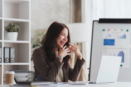 Confident business person executive using laptop computer, having video conference call virtual meeting, advisor finance, research, fundの写真素材