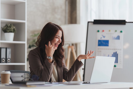 Confident business person executive using laptop computer, having video conference call virtual meeting, advisor finance, research, fundの写真素材