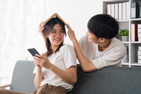 Happy asian family young couple holding piggy bank to save for saving money wealth to buy real estate for new home. Financial planning, business finance conceptの写真素材