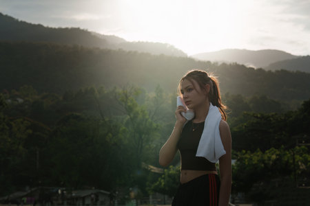 Healthy Asian woman is jogging outdoor. Fitness girl running. Female exercising at outdoor parkの写真素材