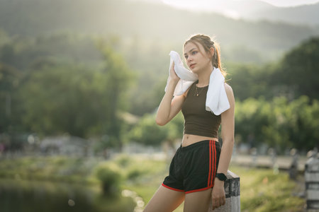 Healthy Asian woman is jogging outdoor. Fitness girl running. Female exercising at outdoor park