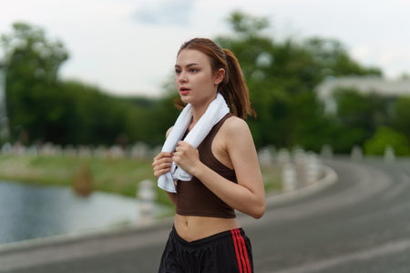 Healthy Asian woman is jogging outdoor. Fitness girl running. Female exercising at outdoor parkの写真素材