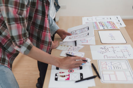 Close up ux developer and ui designer brainstorming interface wireframe design.Creative digital...