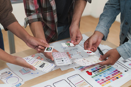Close up ux developer and ui designer brainstorming interface wireframe design.Creative digital...