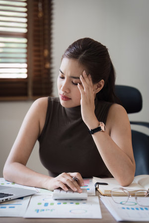 Deadline with young business woman feeling stressed concept. Business woman working at office, business finance conceptの写真素材