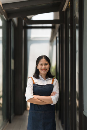 Asian cafe owner or barista standing with smiling at cafe. woman small business owner in food and...