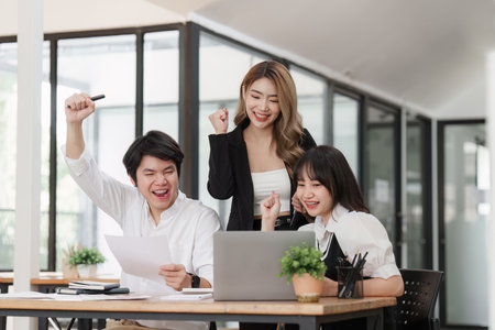 Team of professionals celebrating success at meeting room. business finance, teamworkの写真素材