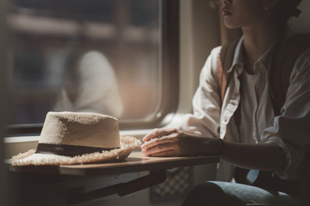 Tourism and travel in the summer. Young asian woman traveling on the trainの写真素材