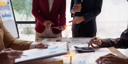 Close up of Diverse colleagues gather brainstorm discuss financial statistics at office meeting. finance, teamwork, Big data Graphs Charts conceptの写真素材
