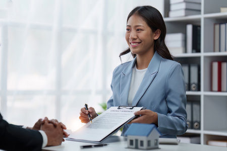 Close up Business people or Real Estate agent explain signing agreement for sale house to client. Property, Insurance, Broker conceptの写真素材