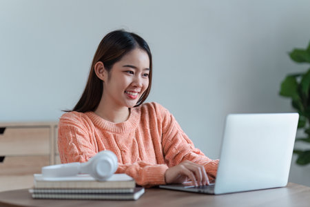 Attractive Asian woman resting comfortable living room and using laptop computer, Relax, Sofa, Lifestyleの写真素材