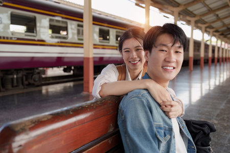 Asian couple at railway station have happy moment. Tourism and travel in the summerの写真素材