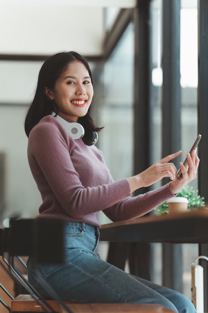 Online store icon, shopping on internet, Asian woman using on virtual screen with hands choosing on smartphone applicationの写真素材
