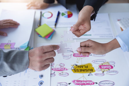 Group of business people putting their hands working together on wooden background in office. group support teamwork agreement conceptの写真素材