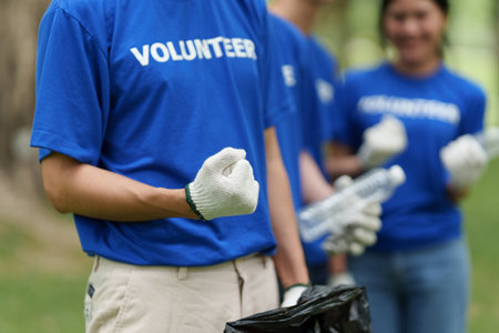 Young Asian Volunteers with garbage bags cleaning park area. Ecology, Charitable organization conceptの写真素材