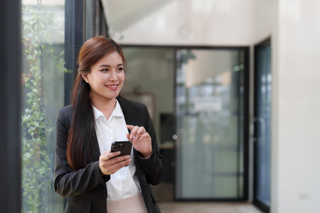 Beautiful business woman talking on the mobile phone. Management, planning and networking phone call conceptの写真素材