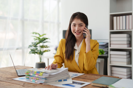 Beautiful business woman talking on the mobile phone. Management, planning and networking phone call conceptの写真素材