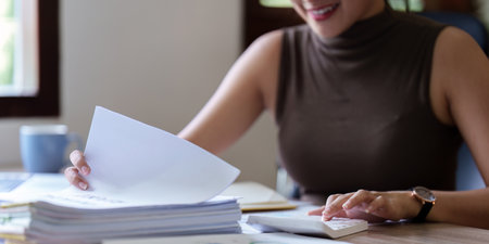 Accountant asian woman working on laptop and do document, tax, exchange, accounting and Financial...