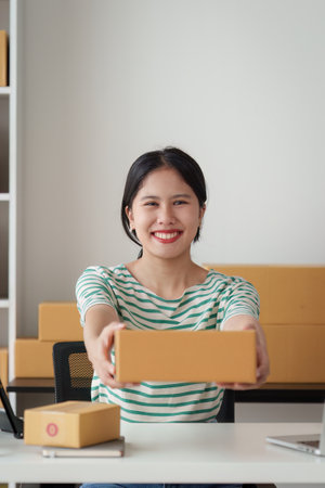 Successful SME entrepreneur. Asian woman working on receipt box and check online orders. business sme conceptの写真素材