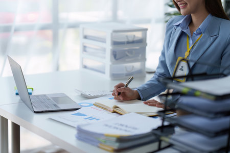 Accountant woman working on laptop and do document, tax, exchange, research, accounting and Financial advisor conceptの写真素材