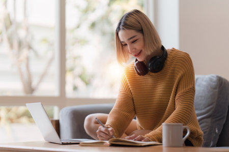 Attractive Asian woman resting comfortable living room and using laptop computer, Relax, Sofa, Lifestyleの写真素材