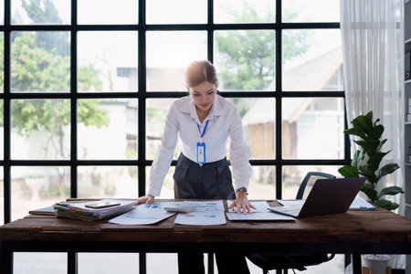 Business woman analyzing financial and investment data ,business planning and strategy on blue backgroundの写真素材