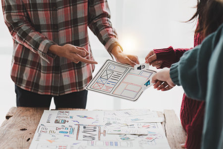 Close up ux developer and ui designer brainstorming interface wireframe design.Creative digital development agencyの写真素材