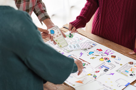 Close up ux developer and ui designer brainstorming interface wireframe design.Creative digital...