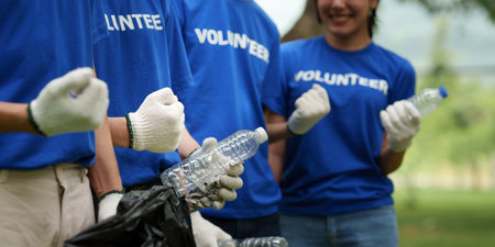 Young Asian Volunteers with garbage bags cleaning park area. Ecology, Charitable organization conceptの写真素材
