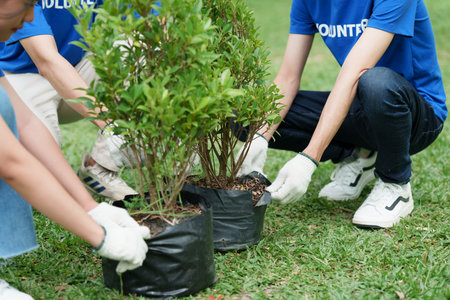 Young Asian Volunteers with garbage bags cleaning park area. Ecology, Charitable organization conceptの写真素材