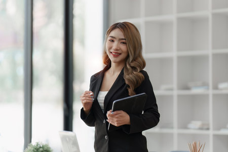 Accountant woman working on laptop and do document, tax, exchange, research, accounting and Financial advisor conceptの写真素材