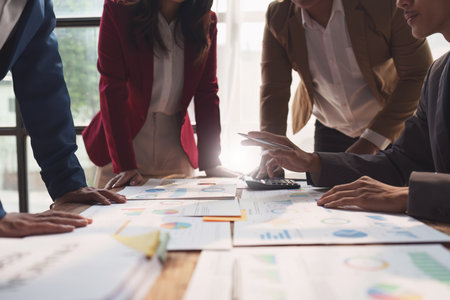 Close up of Diverse colleagues gather brainstorm discuss financial statistics at office meeting. finance, teamwork, Big data Graphs Charts conceptの写真素材