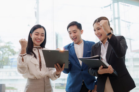 Diverse business team celebrate and collaboration and analyze financial data for long term investmentsの写真素材