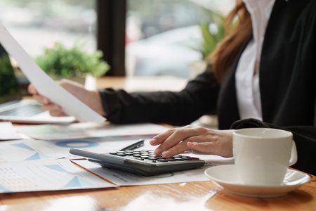 Accountant woman working on laptop and do document, tax, exchange, research, accounting and...
