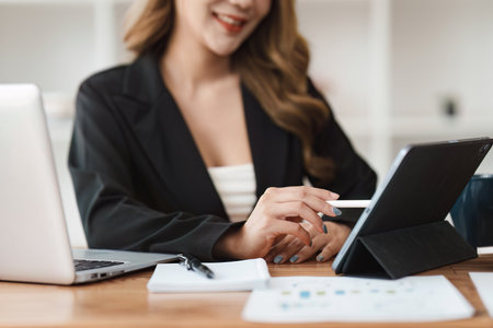 Accountant woman working on laptop and do document, tax, exchange, research, accounting and Financial advisor conceptの写真素材