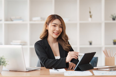 Accountant woman working on laptop and do document, tax, exchange, research, accounting and Financial advisor conceptの写真素材