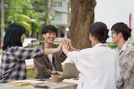Beautiful young Asian people college student with friends at outdoors. College student working on the college campus.の写真素材
