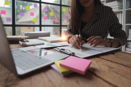 Accountant woman working on laptop and do document, tax, exchange, research, accounting and Financial advisor conceptの写真素材