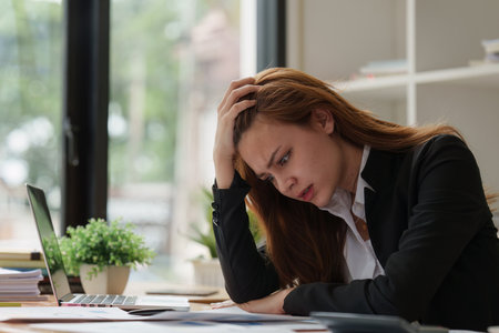 Deadline with young business woman feeling stressed concept. Business woman working at office, business finance conceptの写真素材